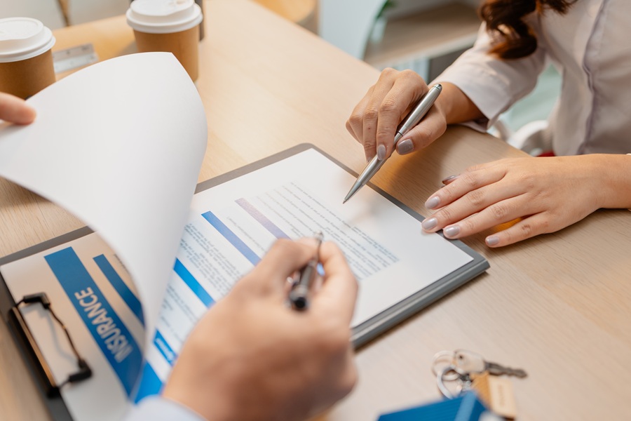 Insurance agent reviewing a homeowners insurance policy with an Irvine, California homeowner - covering dwelling, personal property, and California-specific perils