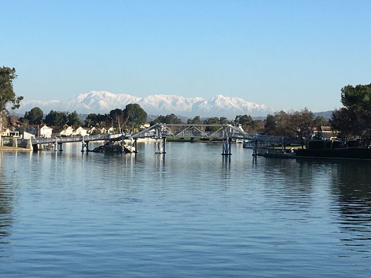 South Lake in Woodbridge Irvine with snowy mountains in the distance and homes along the waterfront