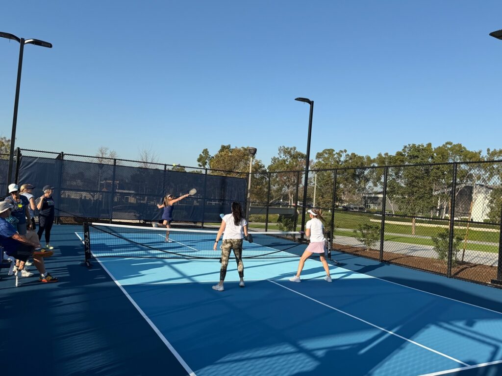 Residents playing pickleball on a Woodbridge community court in Irvine, California