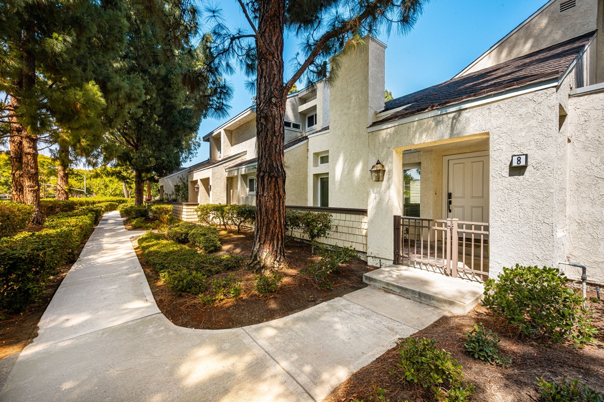 Two-story exterior of 8 Claret, a Chateaux tract condominium in Woodbridge, Irvine, listed by Debbie Sagorin