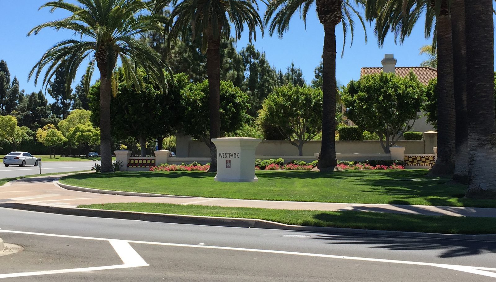 Westpark community entrance monument on a palm-lined street in Irvine, California